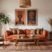 African Living room showcasing African interior design ideas including a terracotta sofa, patterned throw pillows, a rug with colorful motifs, a woven pendant lamp, a wooden armchair with cream cushions, a wooden side table with a bowl on it, a small tree and a wooden coffee table with decor items on it