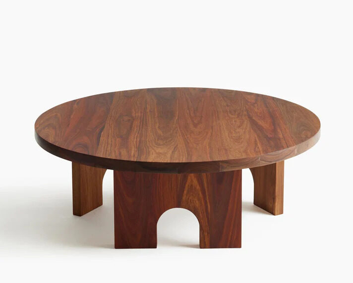 African Living room furniture: A round wooden coffee table with carved feet