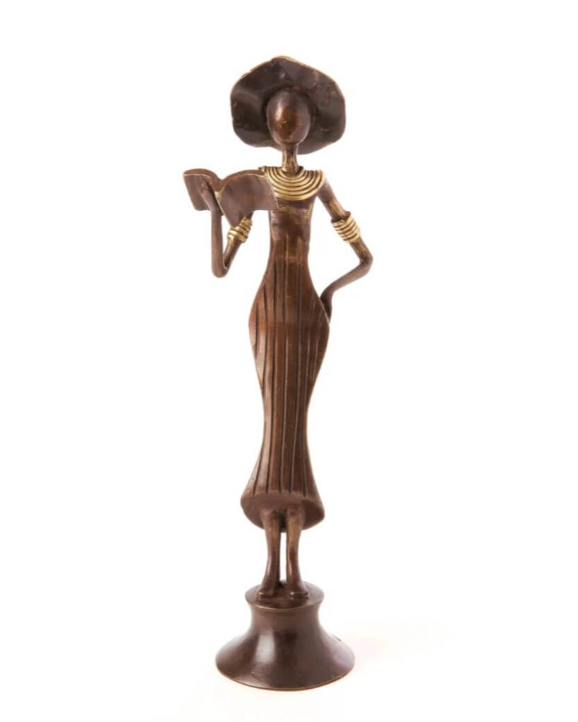 Gifts for Interior Design lovers - A bronze figure from Burkina Faso depicting a woman reading in an elegant standing posture