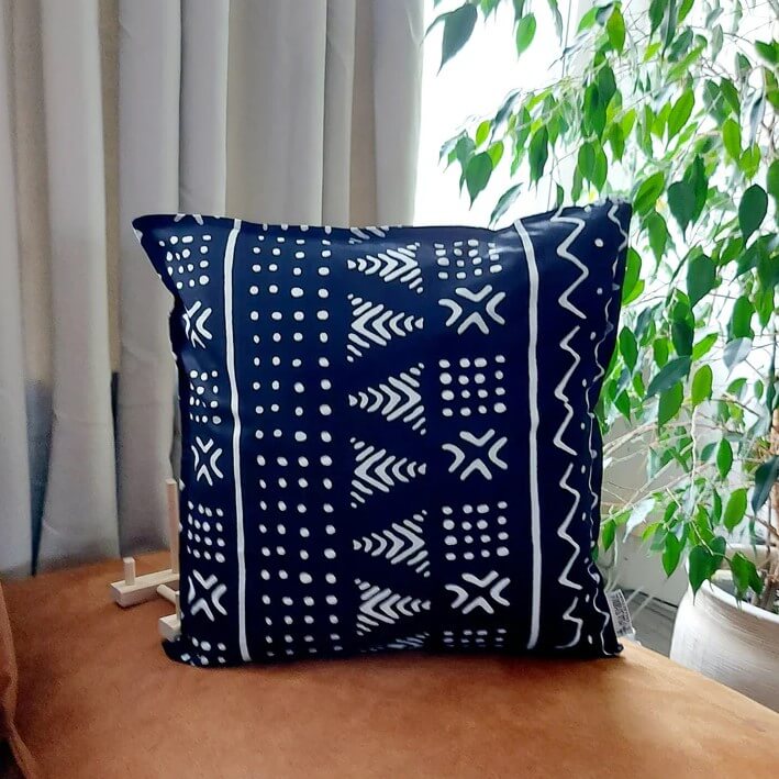 A navy blue cushion with light blue Bogolan symbols, also named Mud cloth