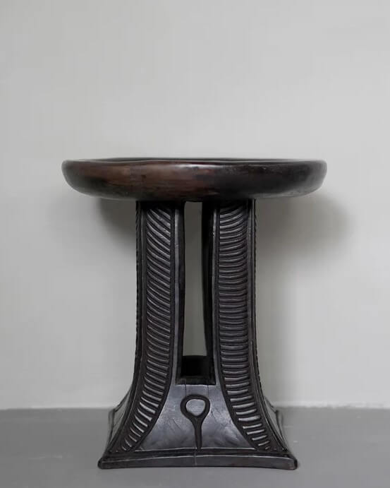 Gifts for Interior Design lovers - A dark-wood stool from Cameroon with legs intricately handcarved