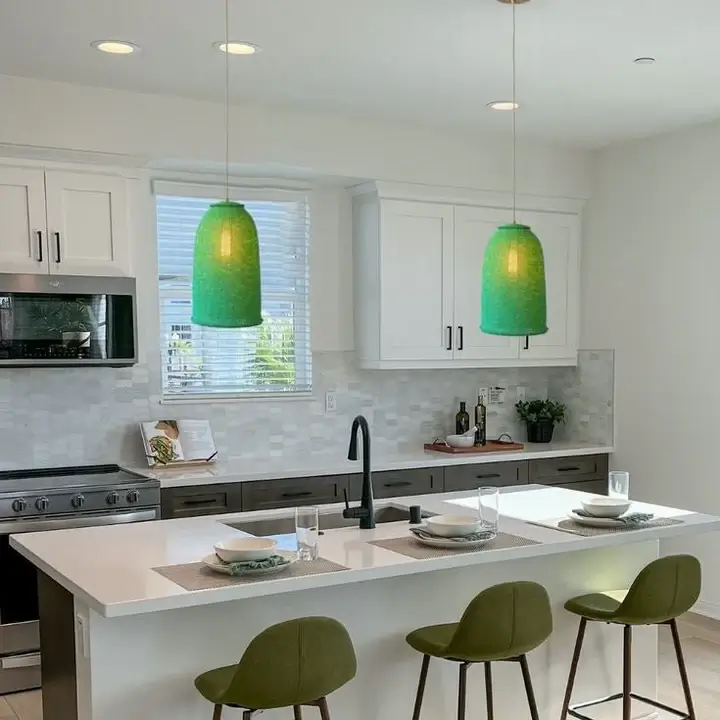 Unique pendant lights over the island of a modern kitchen: Entirely beaded with green beads, made in Zimbabwe