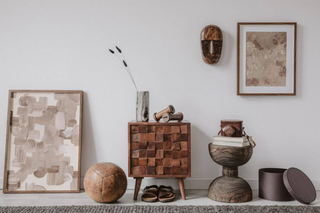 African wall decor: Wooden African mask hanged on a wall within a display of other decor items