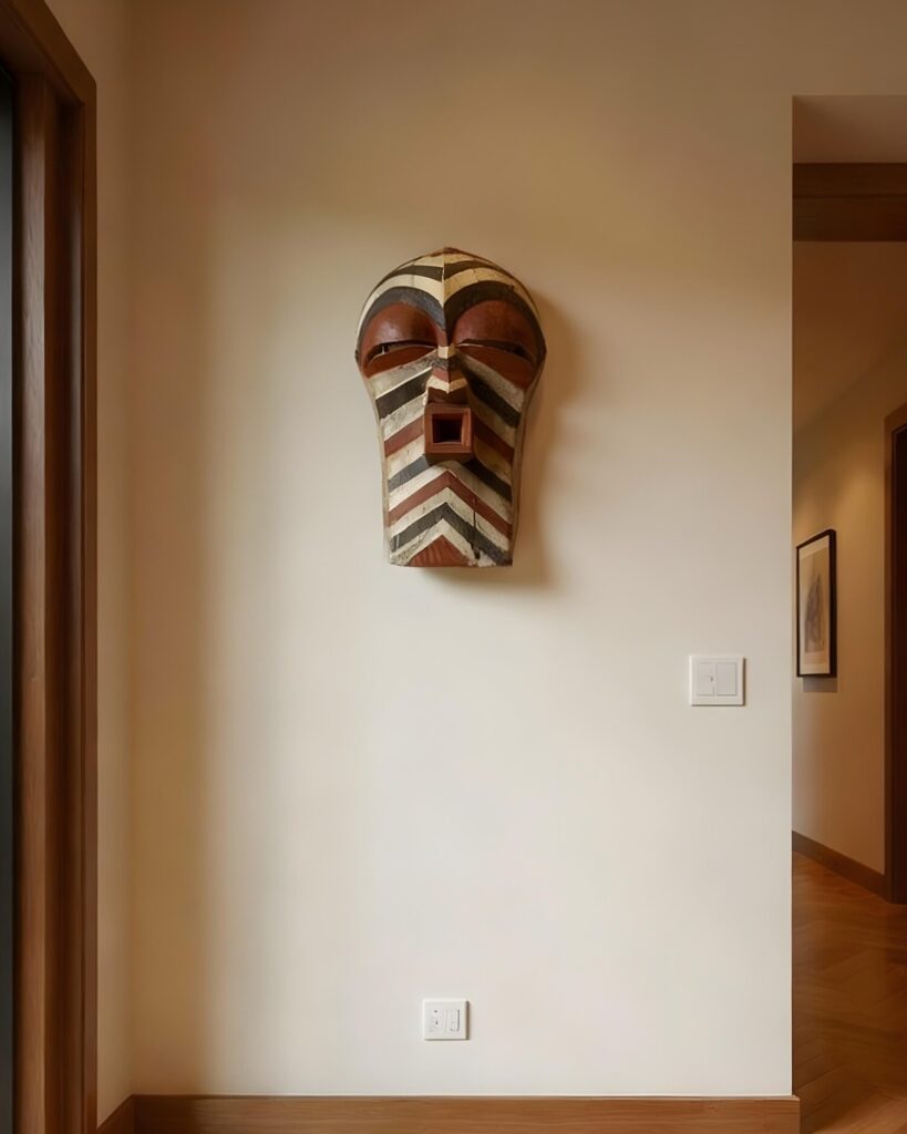 Striking Songye mask hanged on the wall of a modern home