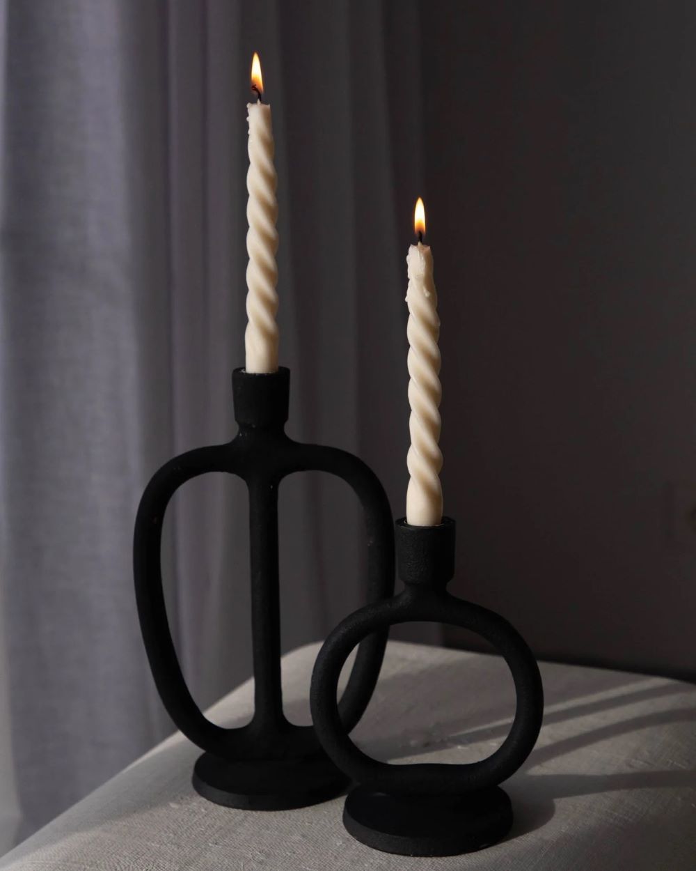 Tall swirly candles over modern black candlesticks