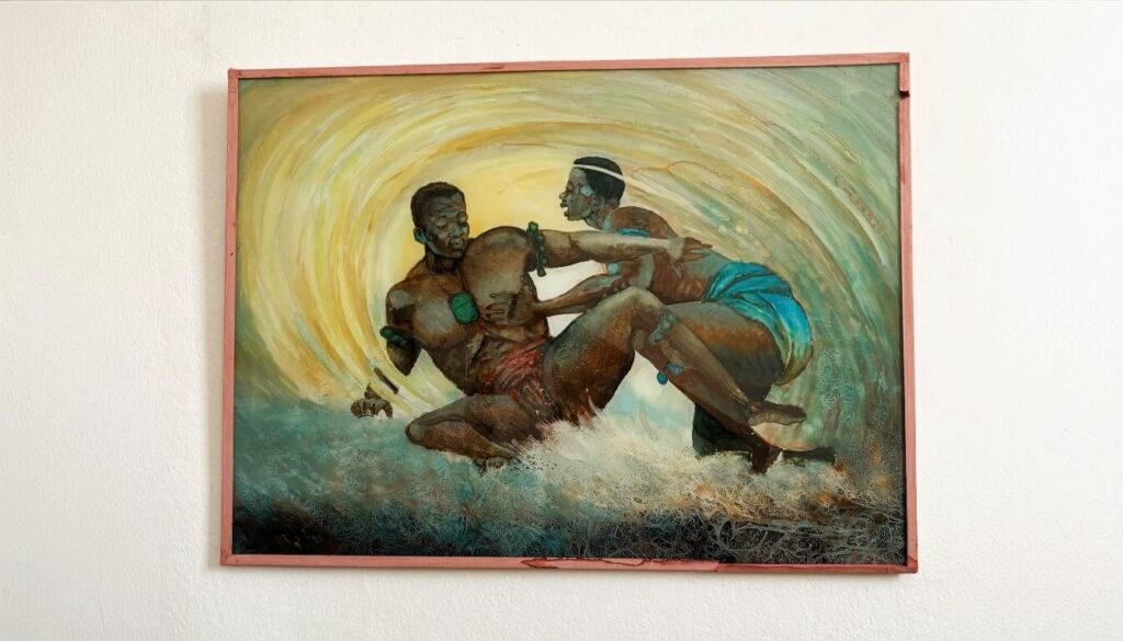 Sunning Reverse glass painting hanged on a white wall, depicting two Senegalese wrestlers in training.