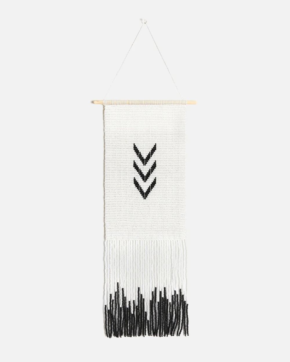 Wall art - fully beaded tapestry in white with black beads in the center representing 3 arrows pointing down and black beads at the bottom of the tapestry