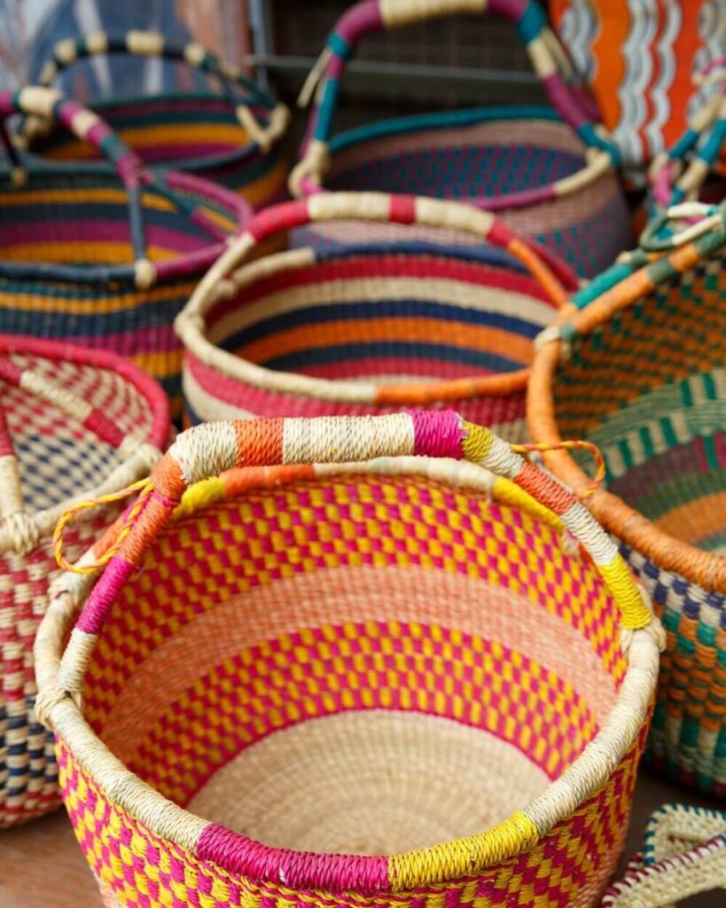 A vibrant collection of handwoven Bolga baskets from Ghana, one of the mos famous type of African baskets, each displaying unique patterns and colors.