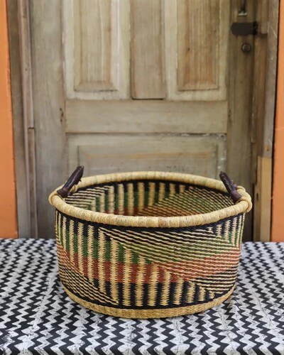 Rustic storage tup basket with dark green and terracotta patterns