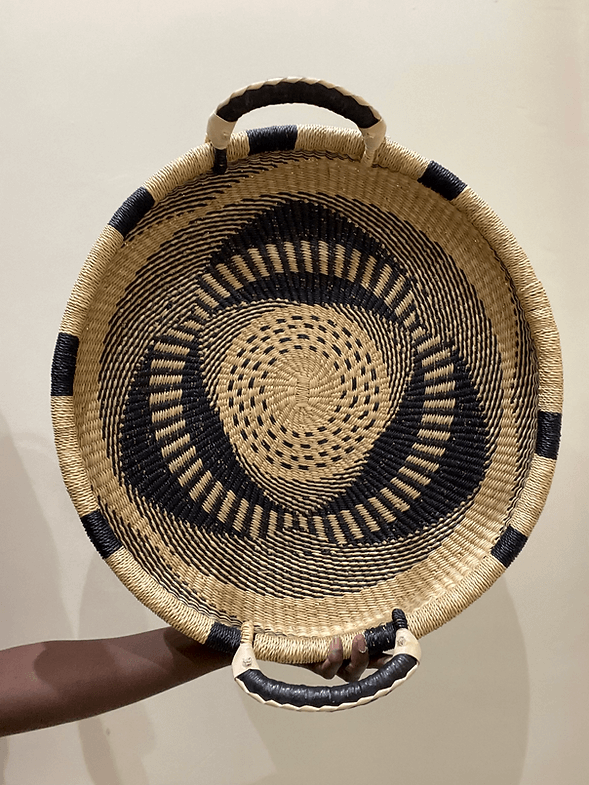 Large natural woven wall basket with black patterns and handles