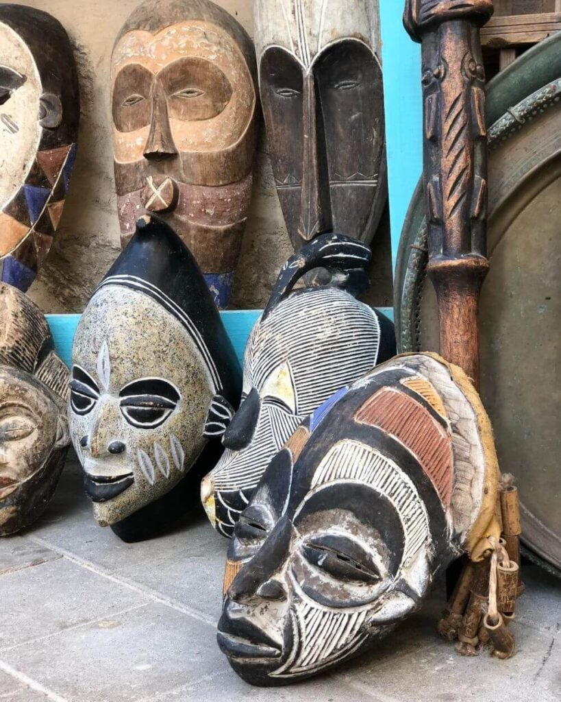An assortment of Traditional African Masks, each with unique textures and patterns, displayed together creating a culturally rich arrangement.