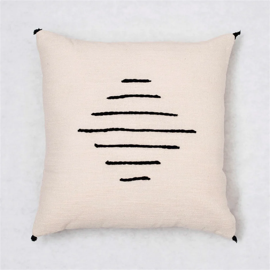 Cream cotton throw pillow with black wool horizontal embroidery