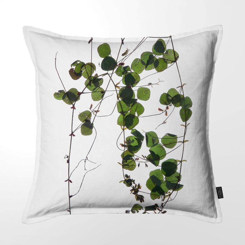 White throw pillow featuring a handpainted motif with stunning green leaves