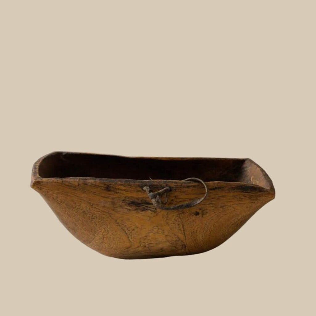 Rustic square African bowl with a weathered wood finish and a simple rope handle. Perfect for adding a vintage touch to your home decor.