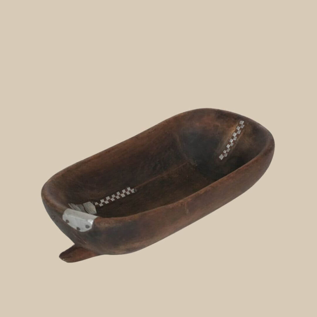 Close-up of decorative, African Tutsi bowl with inlaid checkered metal design.