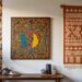 A room with African wall art including a colorful abstract painting, a geometric patterned tapestry and a mural on a white wall. A wooden table holds a potted plant, books, and ceramics.