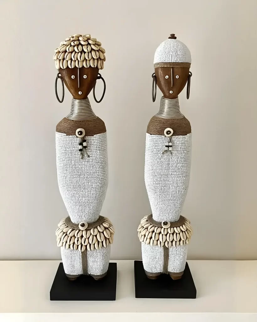 two gorgeous namji dolls decorated with white beads on a shelf - stunning home decor showpieces