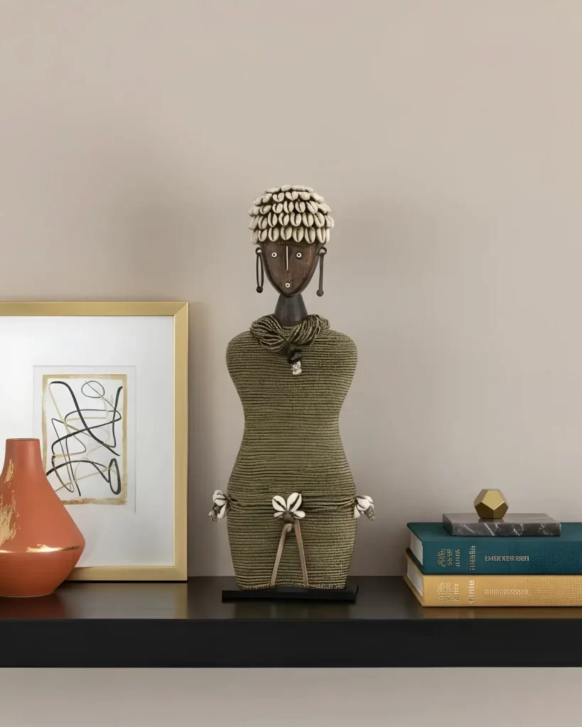a black shelf with elegant decor and a beautiful namji doll with golden beads at the center
