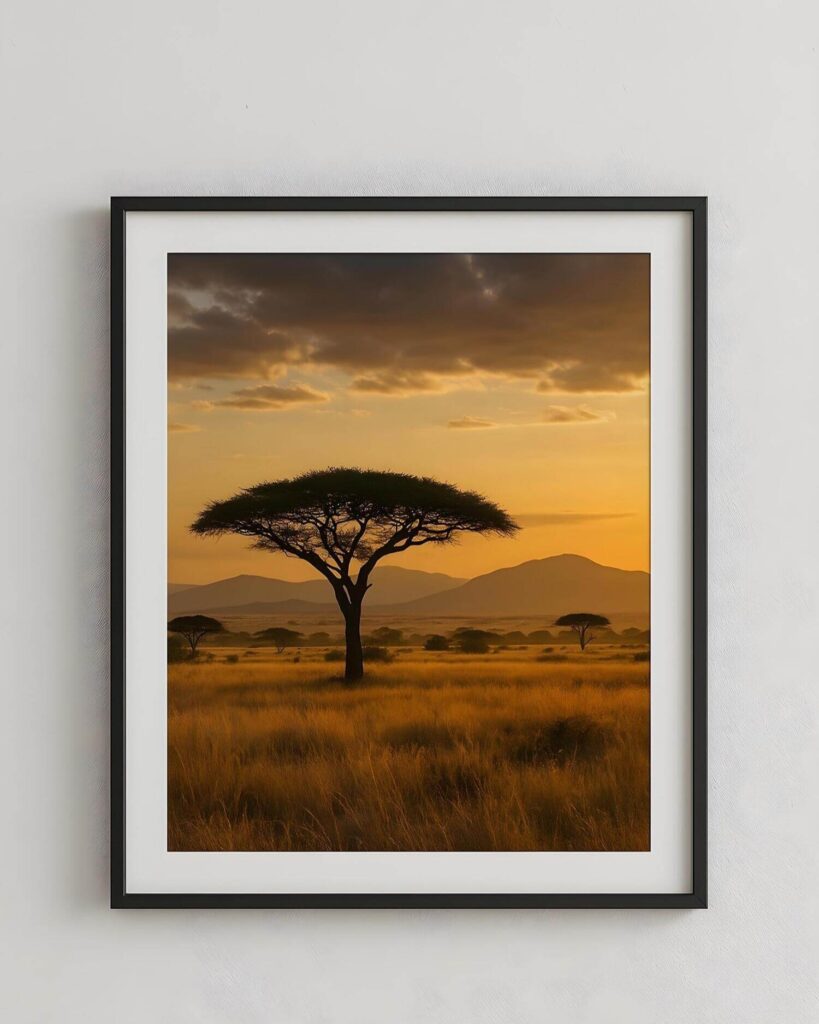 African wall decor: framed photo of a serene African savanna at sunset. Silhouetted acacia tree stands tall against a golden sky, evoking calm and natural beauty.