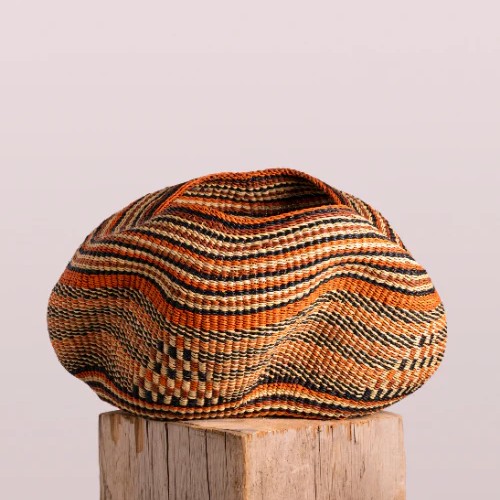 Pebble shaped basket handwoven in Ghana in sunset colors