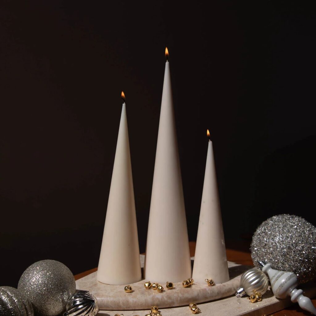 Set of three christmas tree-shaped holiday candles