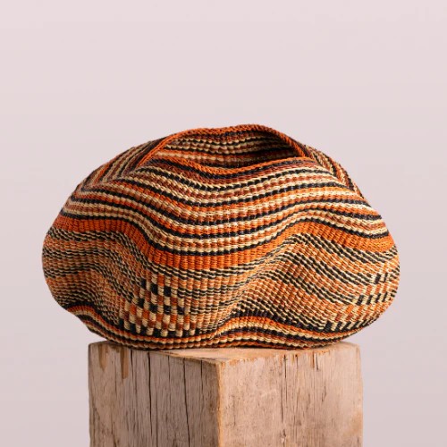 Handwoven bowl basket in beautiful earthy colors and a shape resembling a Pebble. Gorgeous patterns and details
