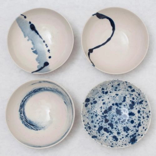 Set of four white porcelain bowls hand-painted with blue motifs for an ultra elegant finish
