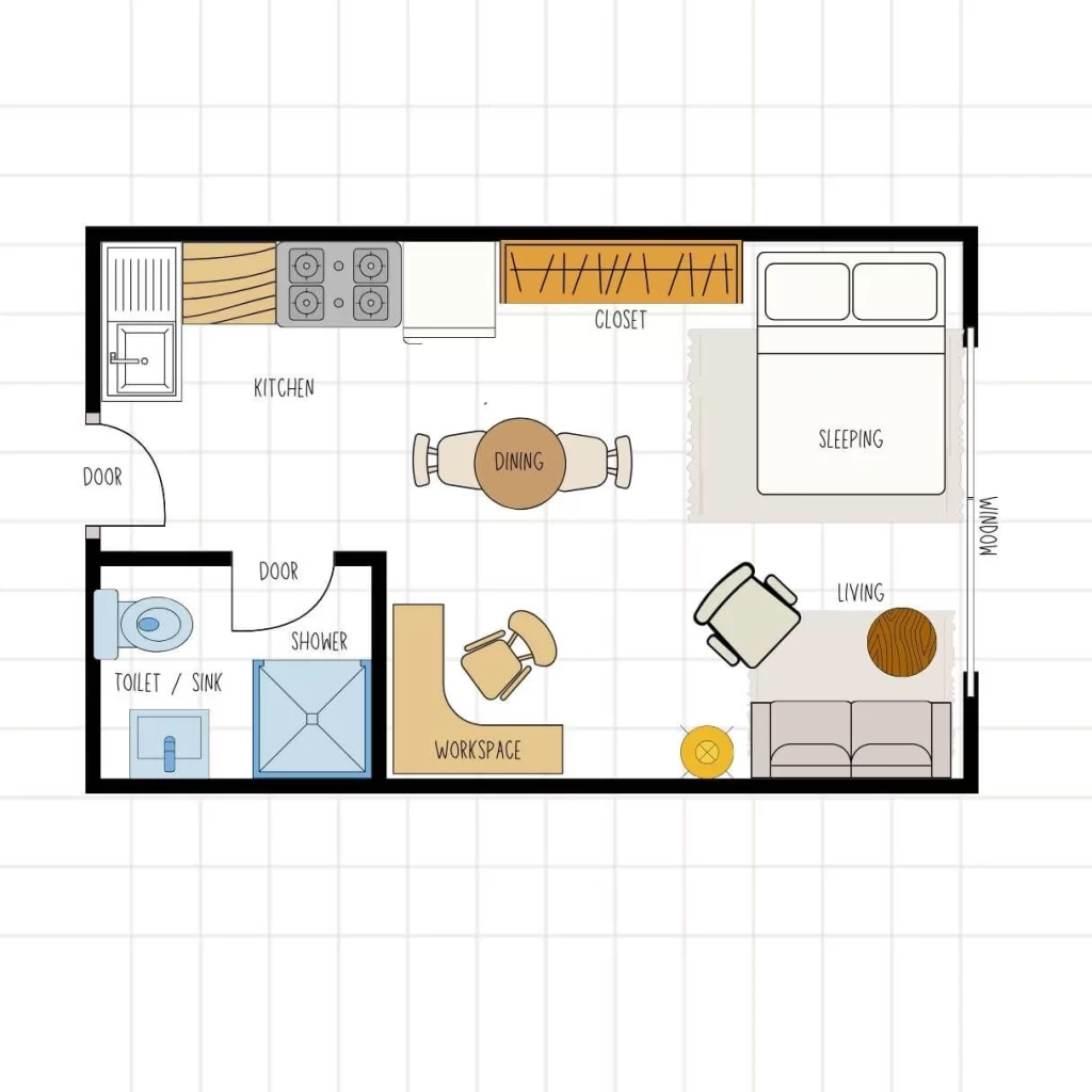 Studio floor plan prioritizing a large L-shaped workspace near the bathroom. The layout includes a kitchen, a two-seat dining table, a sleeping area with a closet, and a smaller, separate living area with a sofa and armchair.